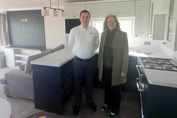 Frank Maguire shows MSP Rachael Hamilton one of his park's holiday home interiors